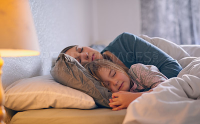 Buy stock photo Shot of a mother and her little girl sleeping in bed together