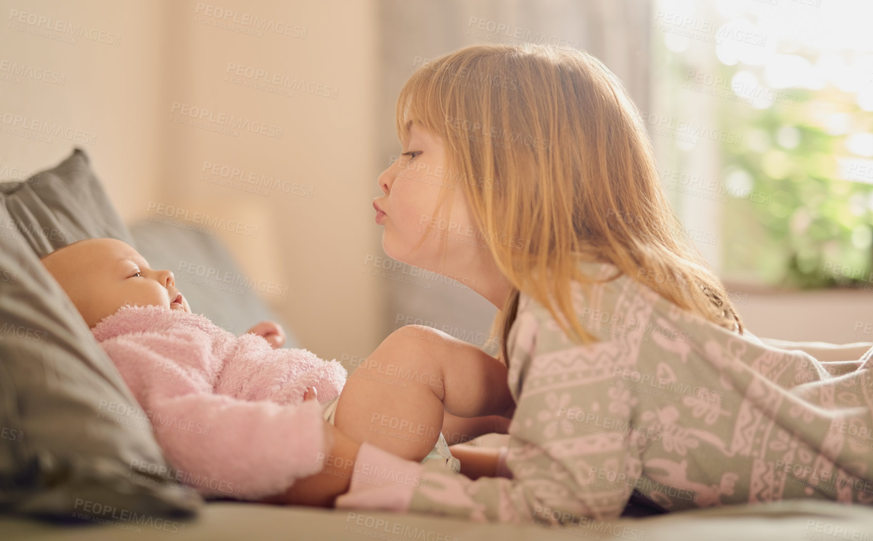 Buy stock photo Family, love and sister kissing baby girl on bed in home together for care, relationship or support. Bedroom, children and youth with sibling kids bonding in apartment for child development or growth