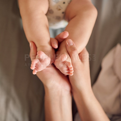 Buy stock photo Baby, feet and closeup with love or care for motherhood, soft skin with security and trust. Newborn, foot and zoom with support and growth for wellness, mother with healthy child or cosmetics