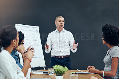 Buy stock photo Shot of a businessman giving a presentation in the boardroom