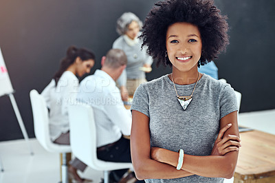 Buy stock photo Portrait of a businesswoman standing with her arms folded in the boardroom while a colleague gives a presentation in the background
