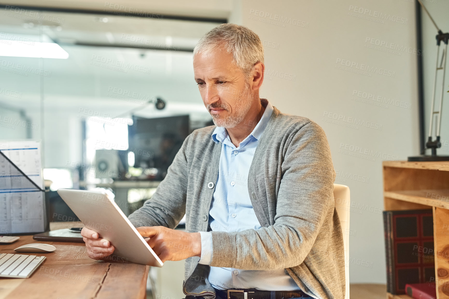 Buy stock photo Mature man, tablet and serious in office, CEO planning and check email at desk for project. Person, entrepreneur and owner of finance firm at workplace, accounting app and website for economy update