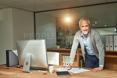 Buy stock photo Portrait of a mature businessman  standing by his desk in his office