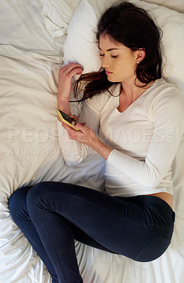 Buy stock photo Tired, woman and smartphone in bed with anxiety, stress and depression for response or message. Social media, female person and mental health with mobile scrolling after breakup or divorce at home
