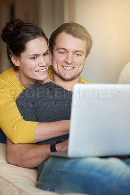 Buy stock photo Shot of a loving couple using a laptop together at home