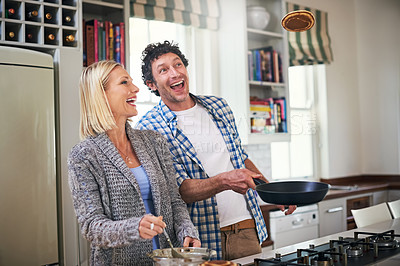 Buy stock photo Shot of a happy couple making breakfast together at home