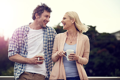 Buy stock photo Couple, coffee and balcony for love on vacation, support and laugh for joke in conversation. People, terrace and trees at holiday resort or tea for warmth on morning, talking and care in romance