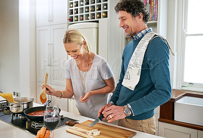 Buy stock photo Couple, stove and laugh while cutting vegetables, love and care for food or meal in kitchen. People, onions and pan for dinner prep and talk for bonding, nutrition and comedy in marriage or home