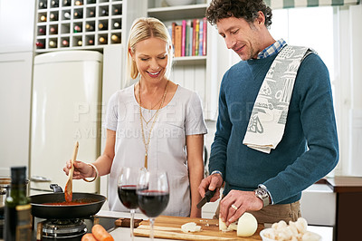 Buy stock photo Couple, stove and cooking while cutting vegetables, love and care for food or meal in kitchen. People, onions and pan for dinner prep and talk for bonding, nutrition and support in marriage in home
