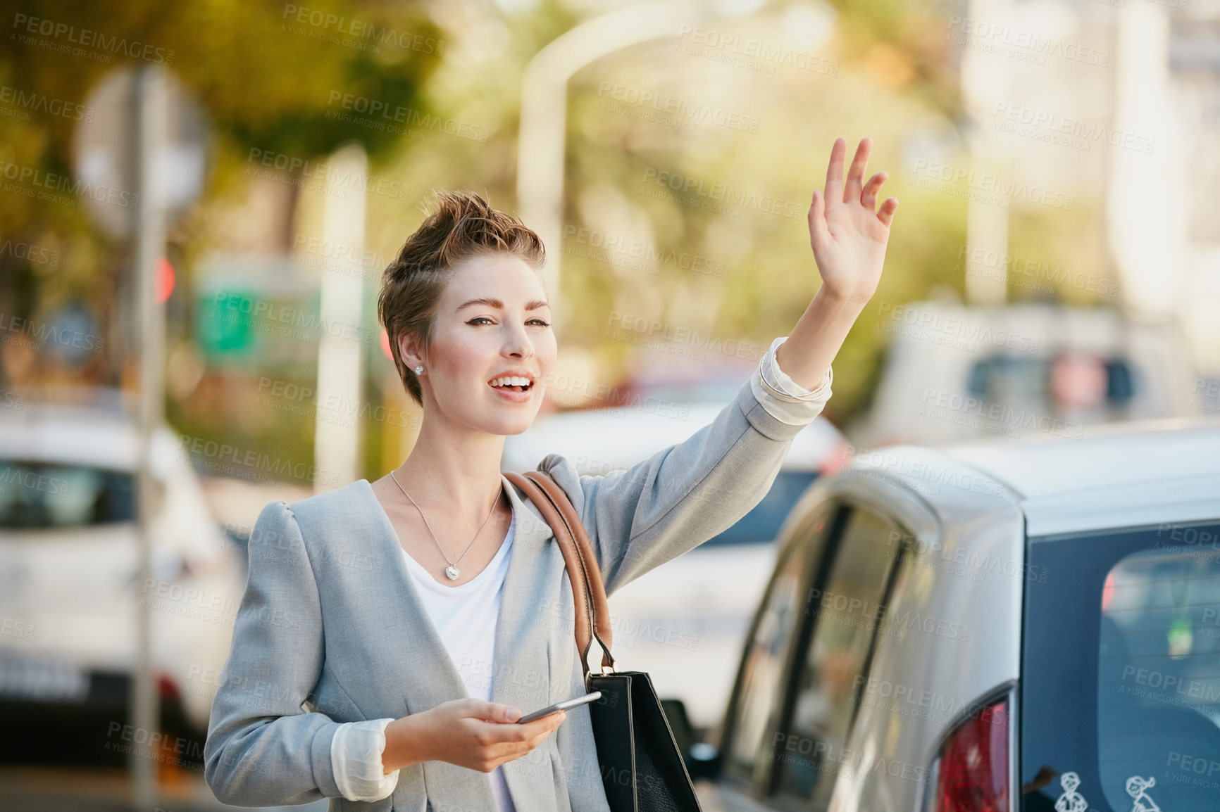 Buy stock photo Cropped shot of a young businesswoman gesturing to get a cab in the city