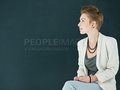 Buy stock photo Cropped shot of a young businesswoman posing against a black background