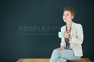 Buy stock photo Cropped shot of a young businesswoman drinking coffee against a black background