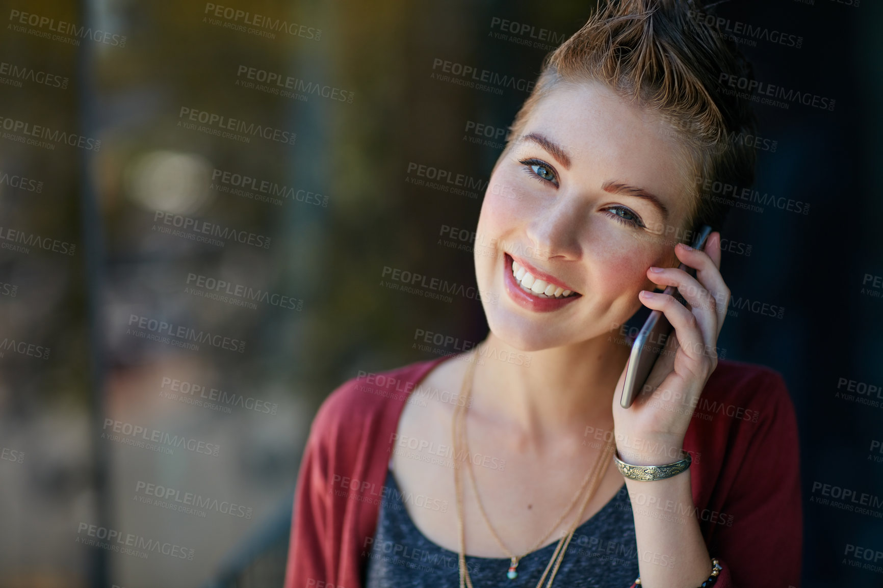 Buy stock photo Portrait of an attractive young businesswoman using her cellphone while standing on her office balcony
