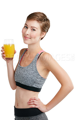 Buy stock photo Studio portrait of a fit young woman holding a glass of orange juice against a white background