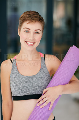 Buy stock photo Portrait of a fit young woman holding an exercise mat