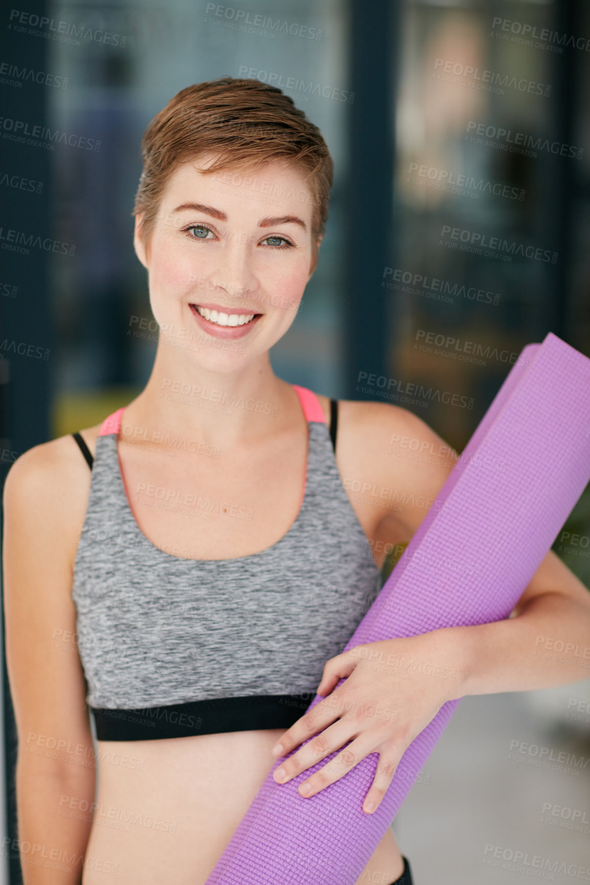 Buy stock photo Portrait of a fit young woman holding an exercise mat