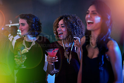 Buy stock photo Shot of a group of friends enjoying themselves at a nightclub