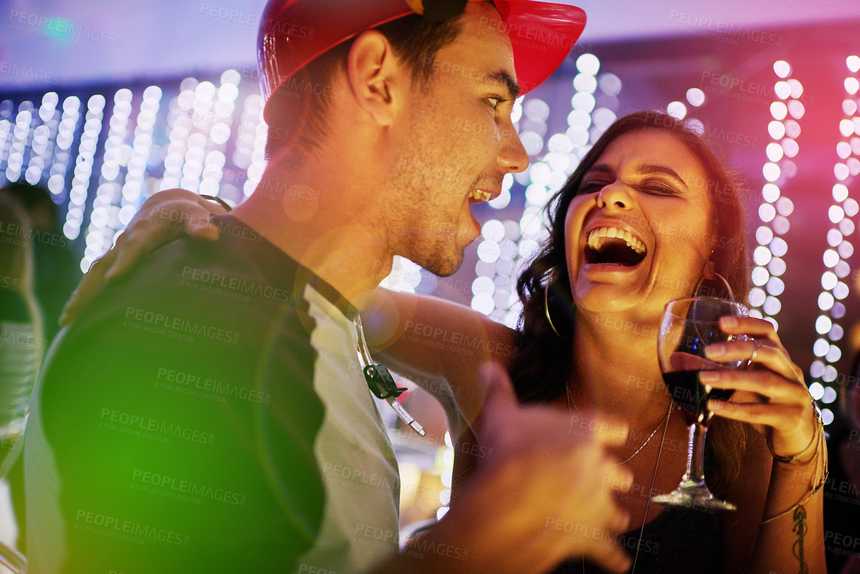 Buy stock photo Drinks, laugh and couple in nightclub for fun, music or happy weekend at social event. Nightlife, man and woman on date at dance club with wine, smile and friends celebrate together in party culture