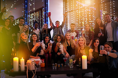 Buy stock photo Shot of a large group of young people enjoying themselves at a nightclub