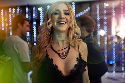Buy stock photo Shot of a beautiful young woman dancing in a nightclub