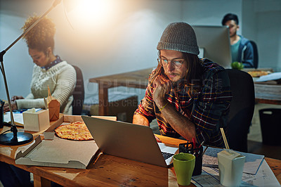Buy stock photo Shot of a group of workers working night shift in an open plan office