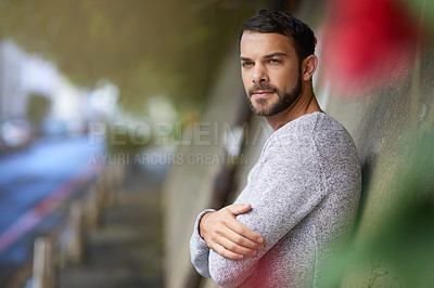 Buy stock photo Shot of a handsome young man out in the city
