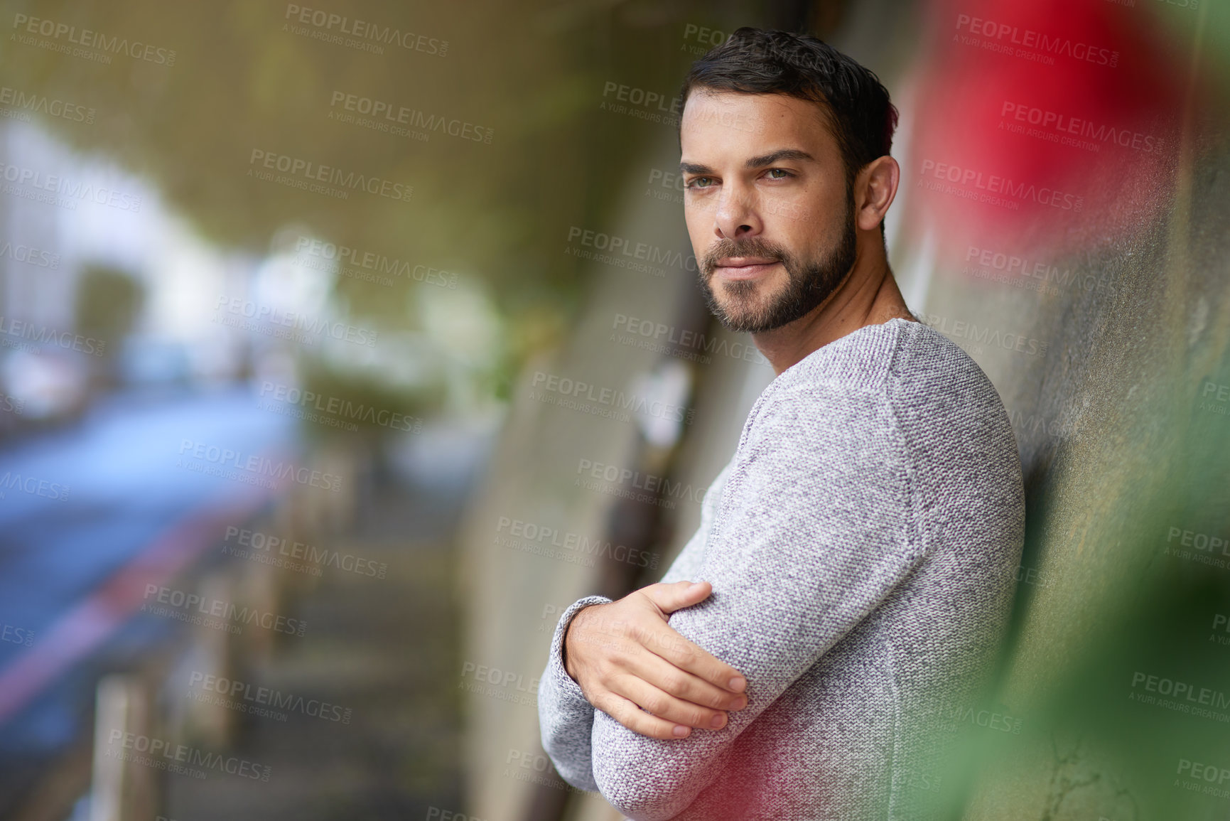 Buy stock photo Shot of a handsome young man out in the city