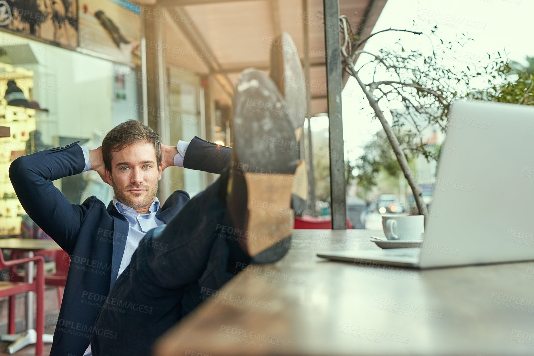 Buy stock photo Portrait of a young businessman looking relaxed while sitting in a coffee shop