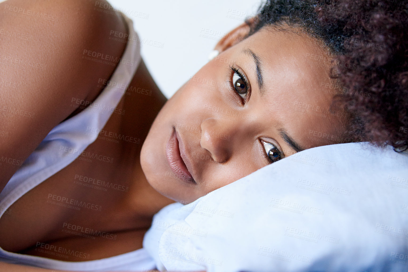 Buy stock photo Closeup shot of a young woman lying down on a pillow against a white background