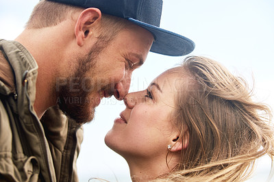 Buy stock photo Shot of an affectionate young couple spending time together outdoors