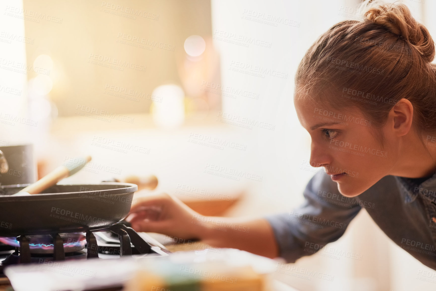 Buy stock photo Cropped shot of a young woman preparing a meal at home