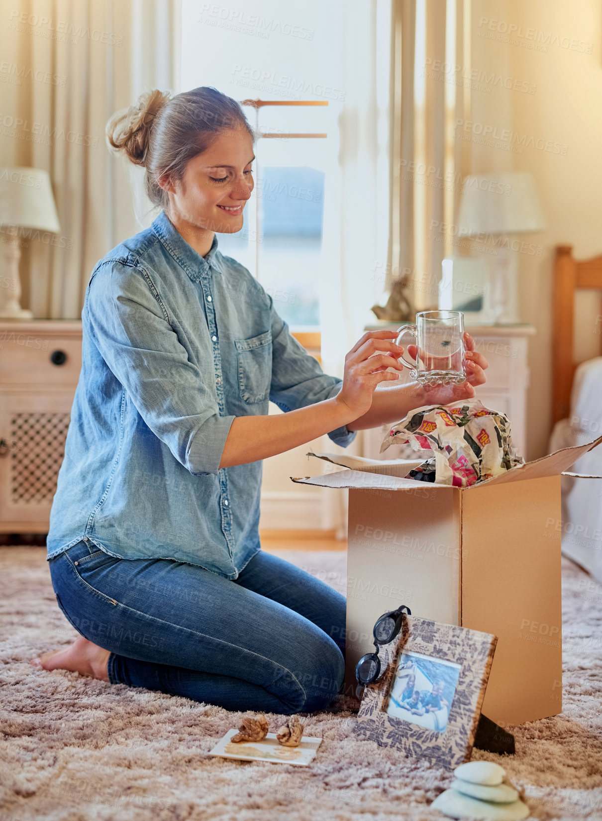 Buy stock photo Cardboard box, woman and new home owner unpacking for mortgage, real estate investment or moving. Bedroom, smile female person with package for happiness, property rent or relocating in apartment