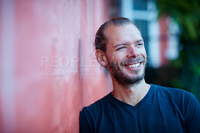 Buy stock photo Portrait of a man leaning against a wall outside