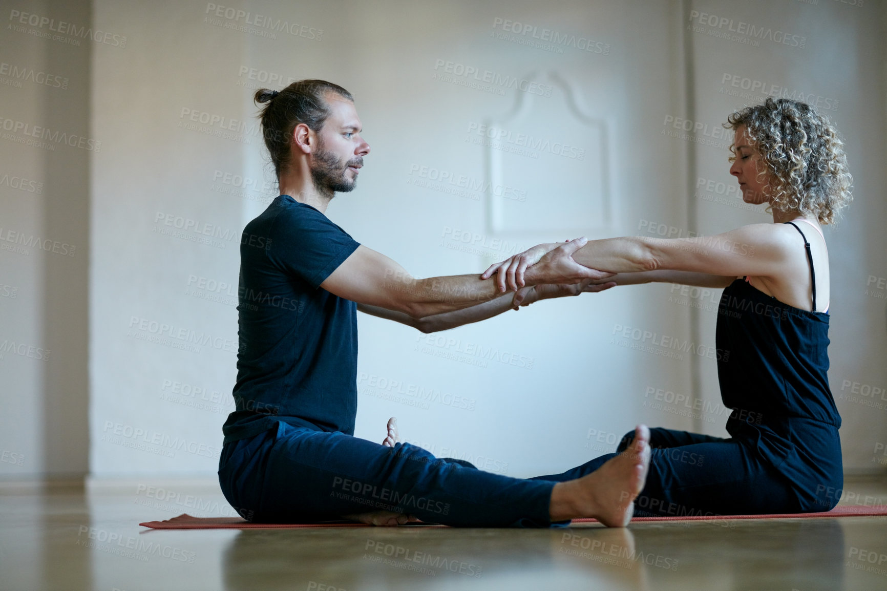 Buy stock photo Shot of a young physical therapist working with his female patient