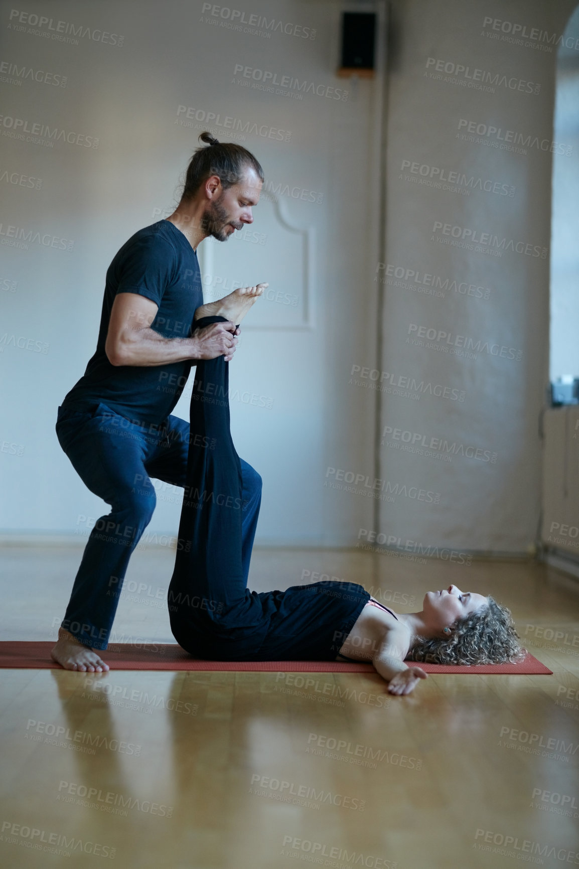 Buy stock photo Shot of a young physical therapist working with his female patient