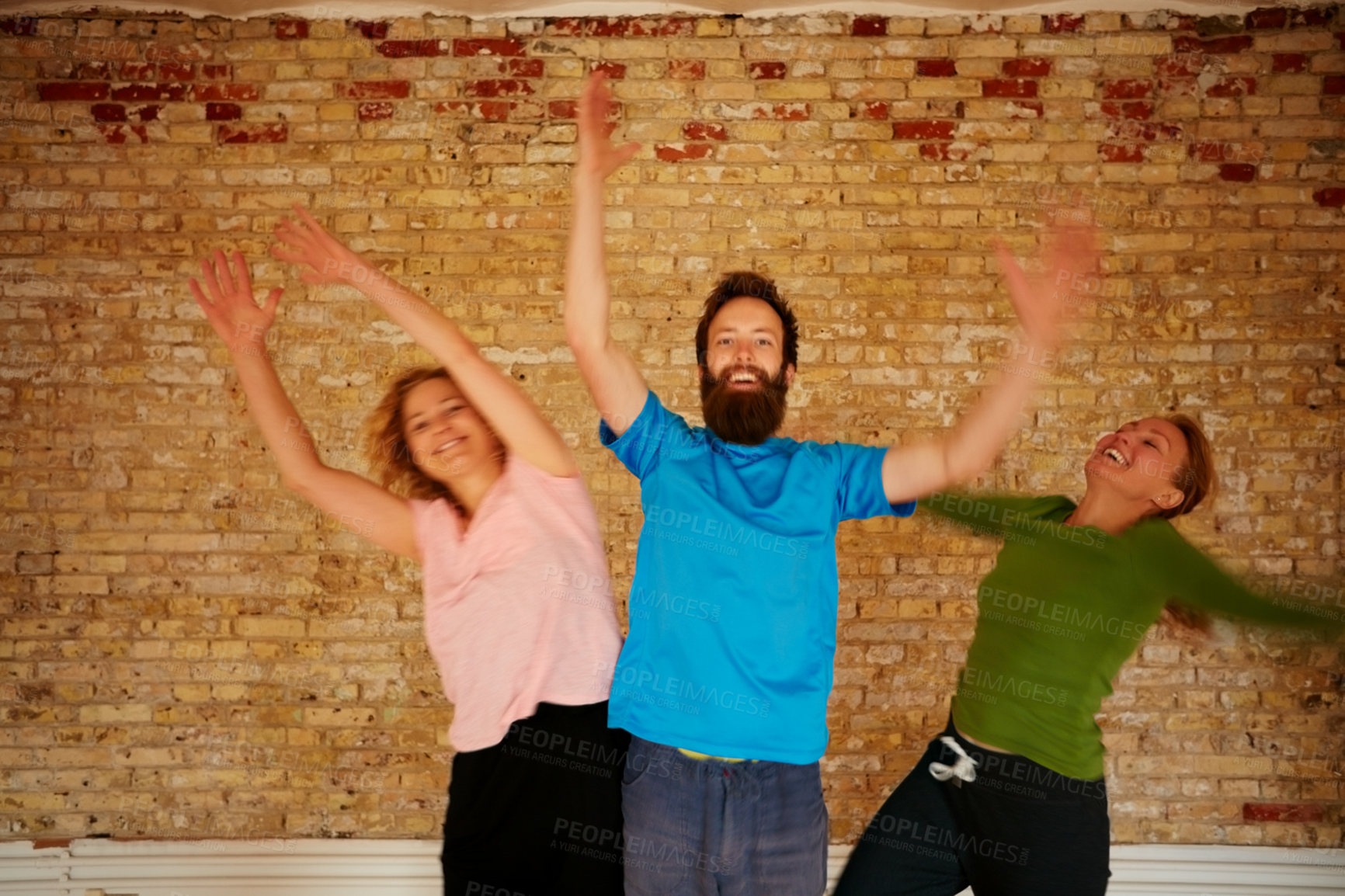 Buy stock photo Shot of a group of yoga enthusiasts standing together in a studio