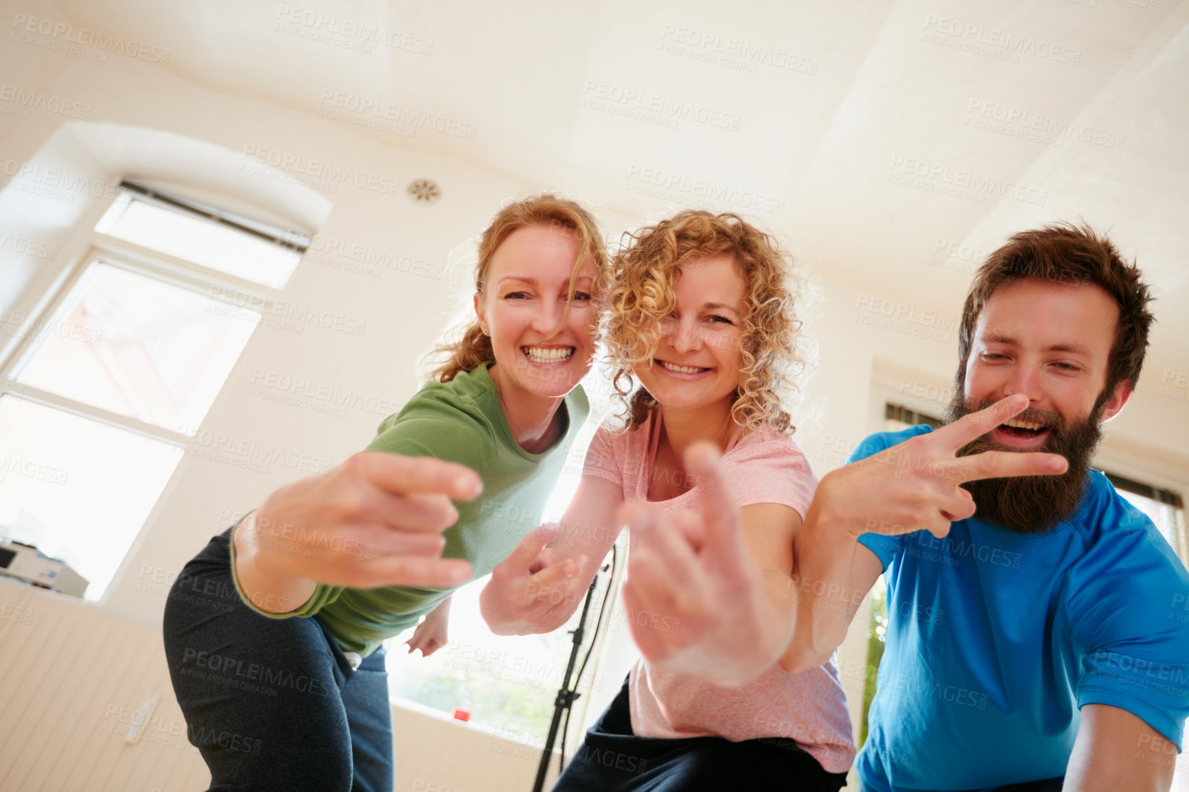 Buy stock photo Shot of a group of yoga enthusiasts standing together in a studio