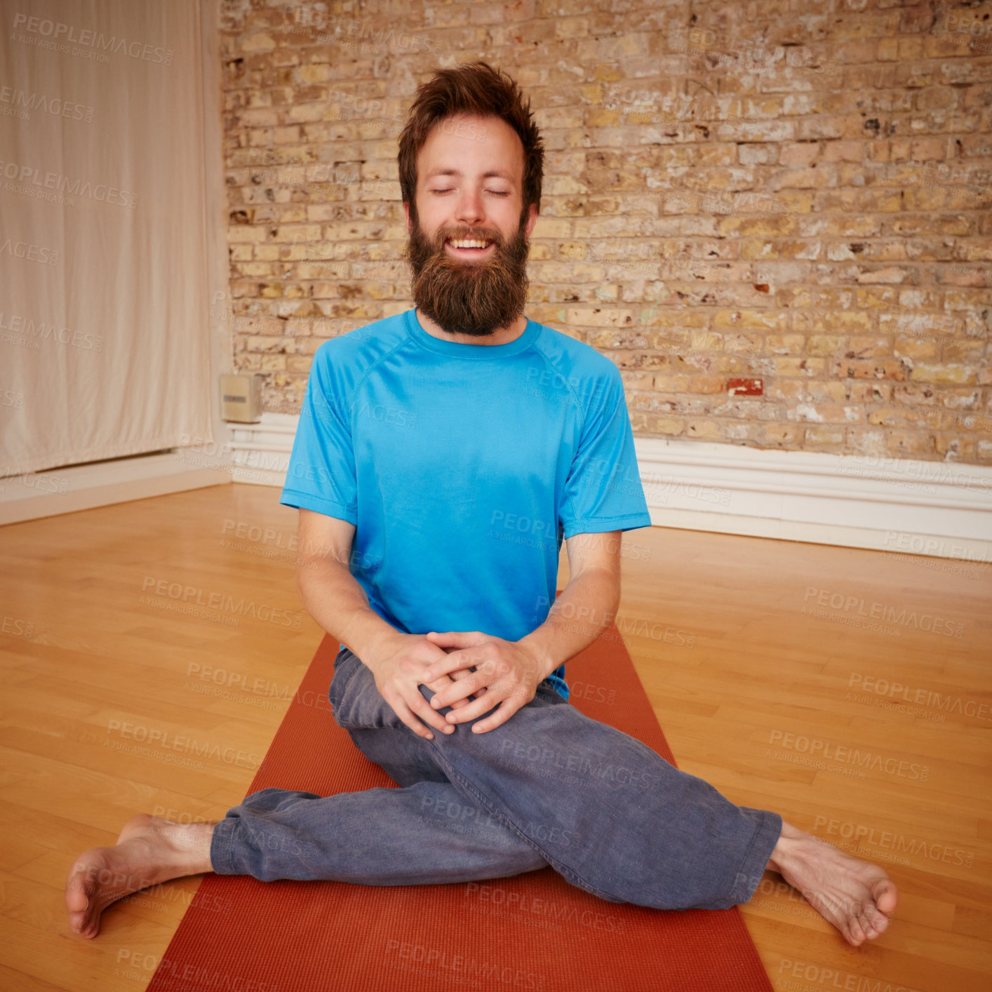 Buy stock photo Shot of a man practising yoga in a studio