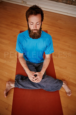Buy stock photo Shot of a man practising yoga in a studio