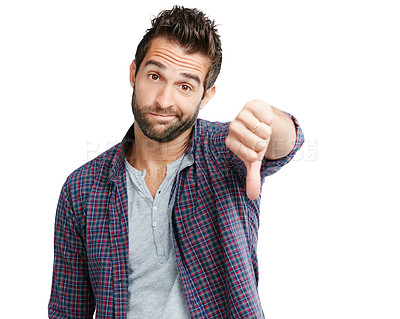 Buy stock photo Studio shot of a young man showing thumbs down against a white background