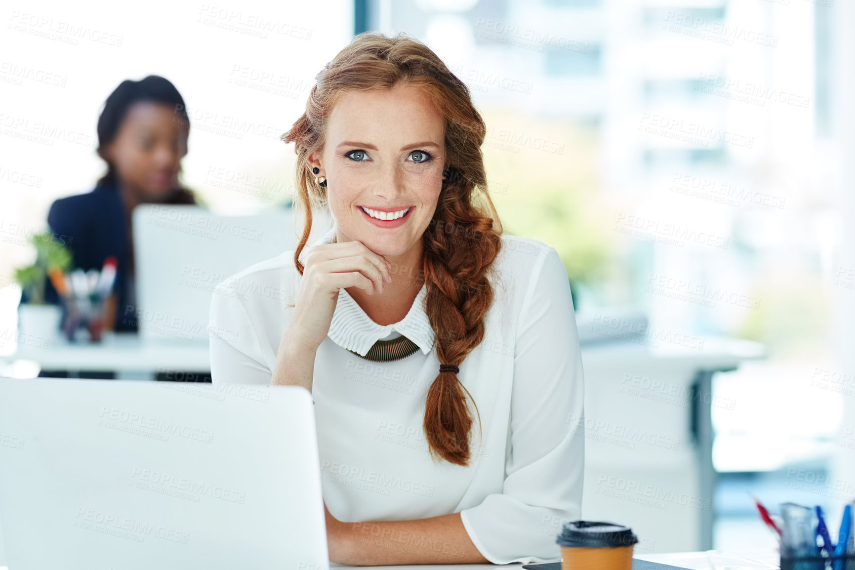 Buy stock photo Portrait of a young businesswoman working in an office with colleagues in the background