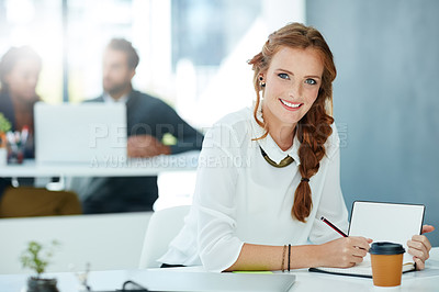 Buy stock photo Portrait of a young businesswoman working in an office with colleagues in the background