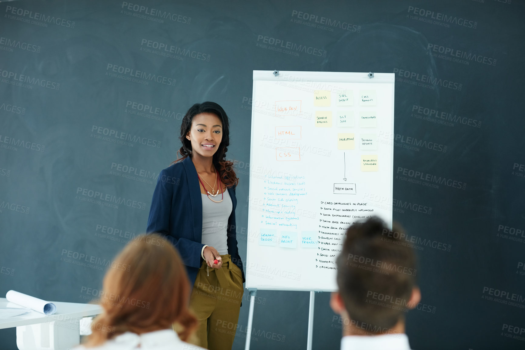 Buy stock photo Cropped shot of a young businesswoman giving a presentation to her colleagues in an office