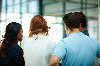Buy stock photo Rear view shot of colleagues having a discussion in an office
