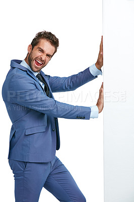 Buy stock photo Studio shot of a handsome businessman pushing a wall against a white background