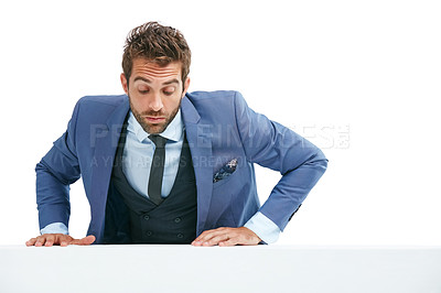 Buy stock photo Studio shot of a handsome businessman climbing a wall against a white background