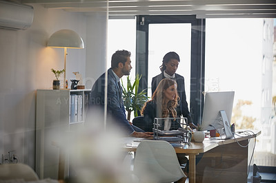 Buy stock photo Cropped shot of colleagues working together on a computer in an office