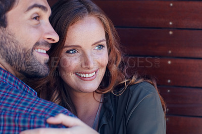Buy stock photo Shot of an affectionate young couple embracing each other