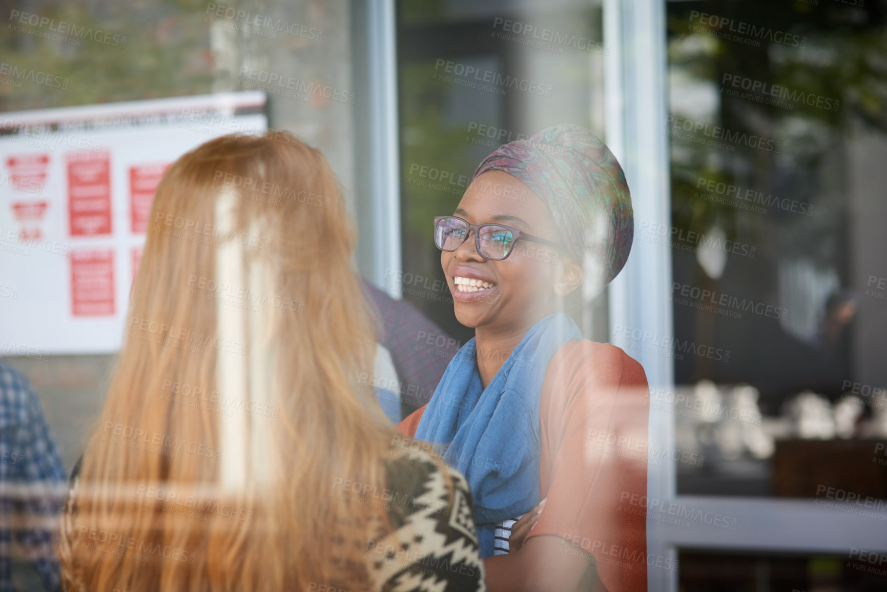 Buy stock photo Cropped shot of two university students socialising on campus