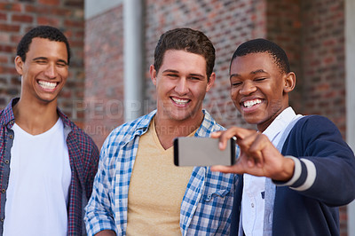 Buy stock photo Cropped shot of a group of university students taking a selfie on campus